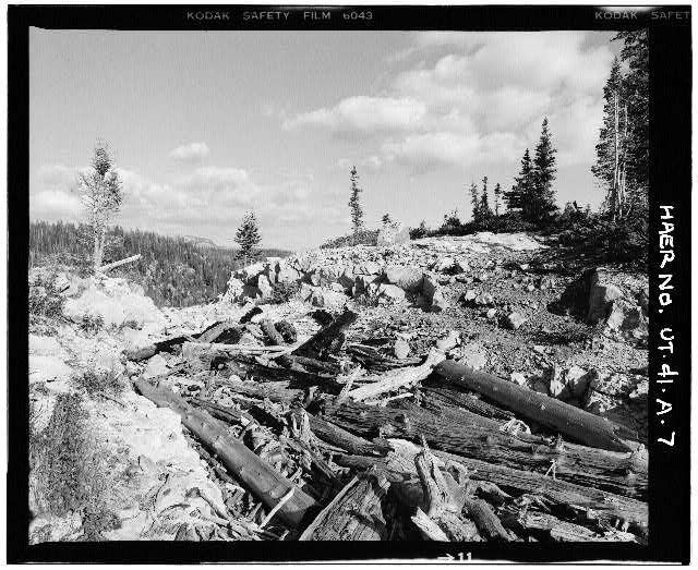 7. VIEW SHOWING DEBRIS-CHOKED STONE SPILLWAY, LOOKING...