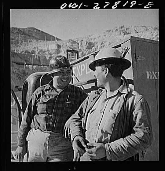 Morenci, Arizona. Three handy workers transport and...