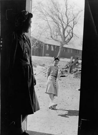 Manzanar, Calif. Apr. 1942--Yaeko Yamashita, in doorway,...