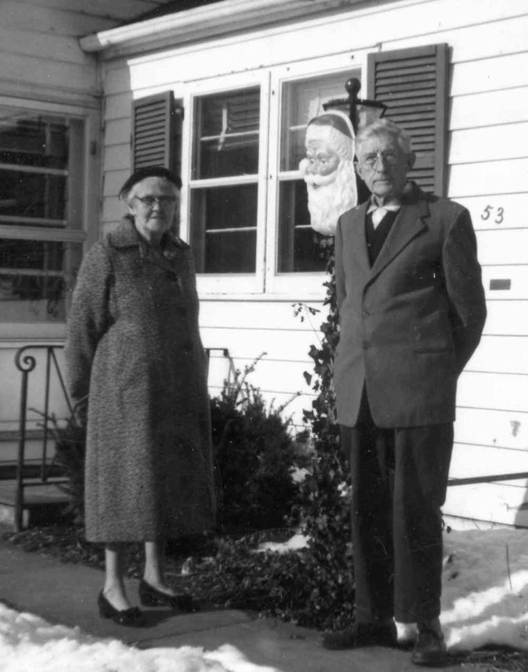 Ruthe and George (Burt) Allen outside new home