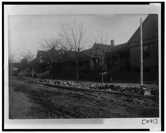 [Exterior view of houses along unpaved street in Georgia]