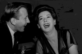 Fred and Rosalind Russell laughing.