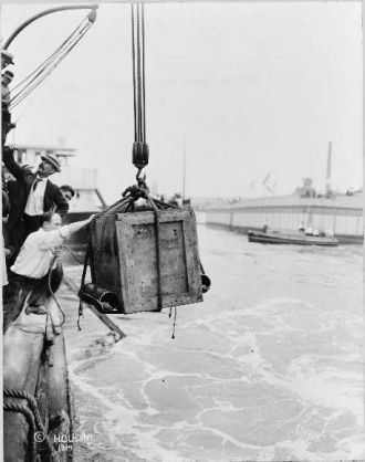 Harry Houdini, being lowered from ship