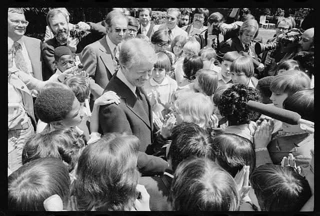 [President Jimmy Carter surrounded by school children in...
