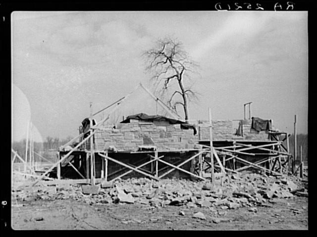 Close up of the stone house which is being built by the...