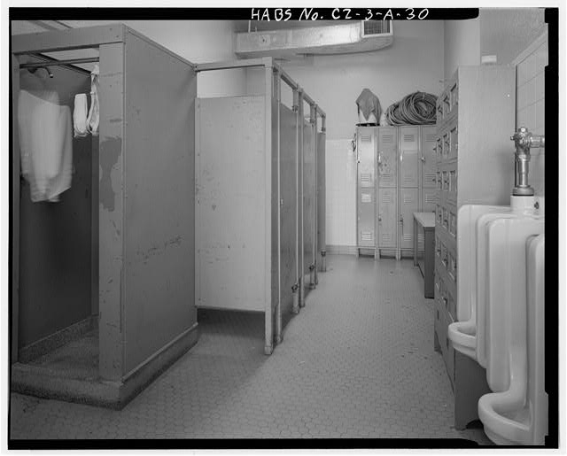 Interior view of first floor men's restroom, facing...