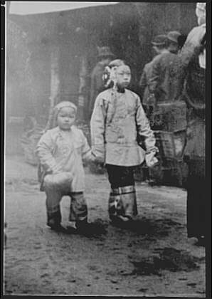 Two children walking down a street, Chinatown, San Francisco