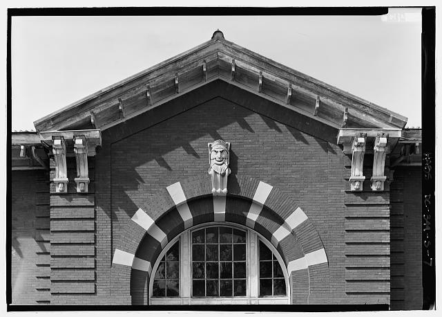 Detail view of arched window and pediment, south...
