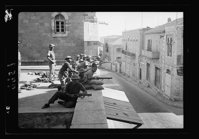 Troops behind sand bags on wall of French hospital, view...