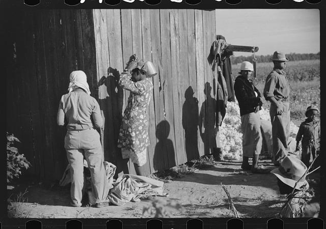 Day laborers by cotton house after picking cotton on...