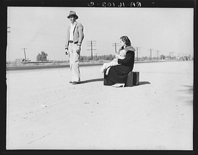Young family, penniless, hitchhiking on U.S. Highway 99,...