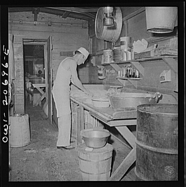 Iden, New Mexico. Baking bread in the kitchen car of the...