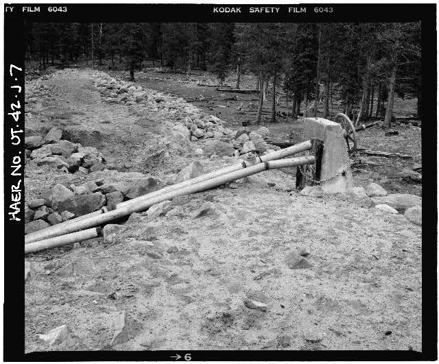 7. VIEW OF INCLINED OUTLET GATE WHEEL AND STEM, LOOKING...