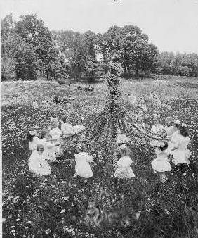 [Little girls, with May pole, and dog in field of...