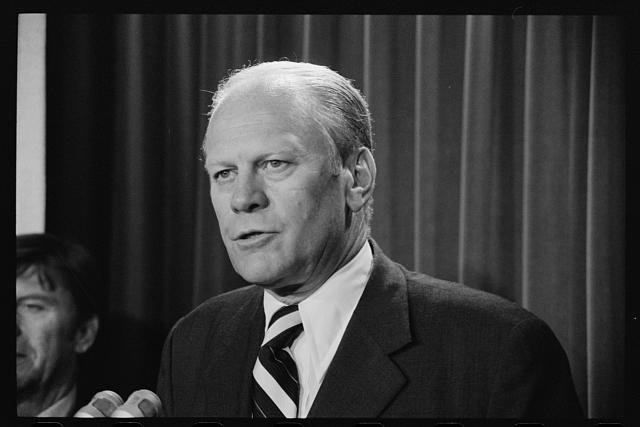 [President Gerald Ford speaking into microphones]