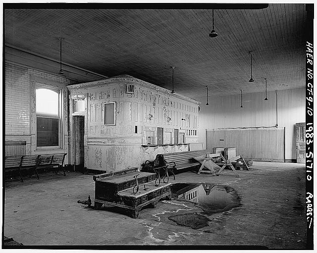 10. 3/4 view of ticketing office inside waiting room of...