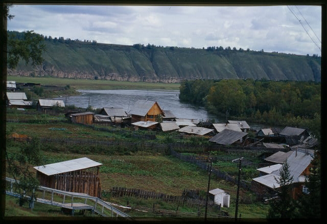 Log houses, with Belaia River in background, Bel'sk, Russia