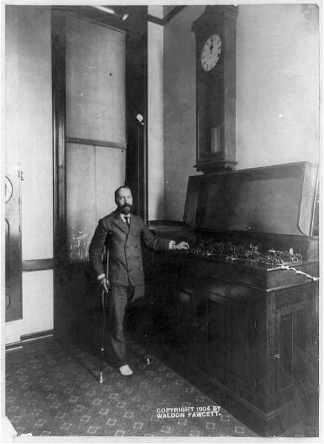 [One-legged man on crutches and instrument, with clock...