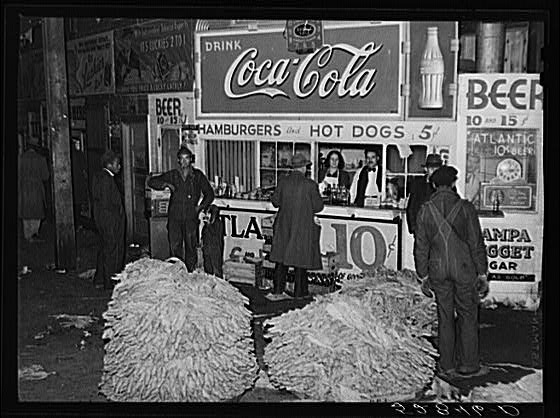 Lunch stand and tobacco inside entrance to warehouse at...