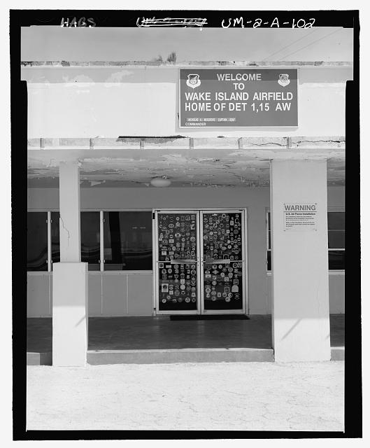 SIGN ON WEST SIDE OF BUILDING ABOVE LANAI ("WAKE ISLAND...
