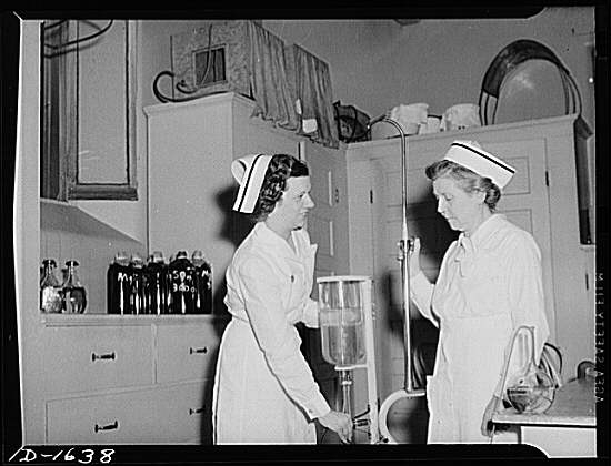 Nurse instructor, left, shows "refresher course" student...