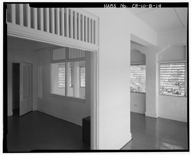 Interior view of bedroom 1 showing transoms, living...