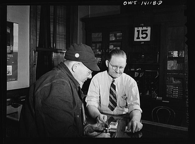 Gibson, Indiana. A railroad worker buying some cigarettes...