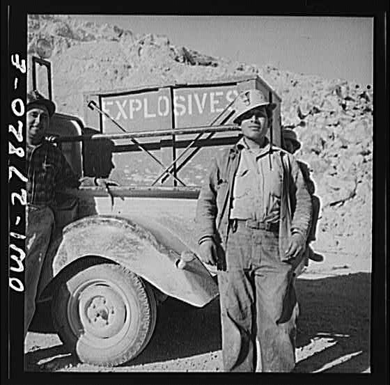 Morenci, Arizona. Three handy workers transport and...