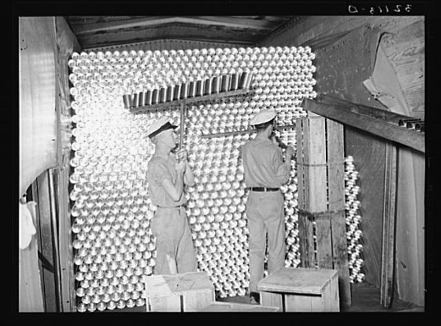 Unloading cans from a boxcar is done by picking them up...