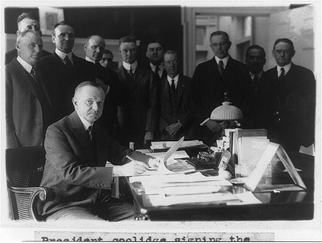 President Coolidge signing the Cameron Bill, which...