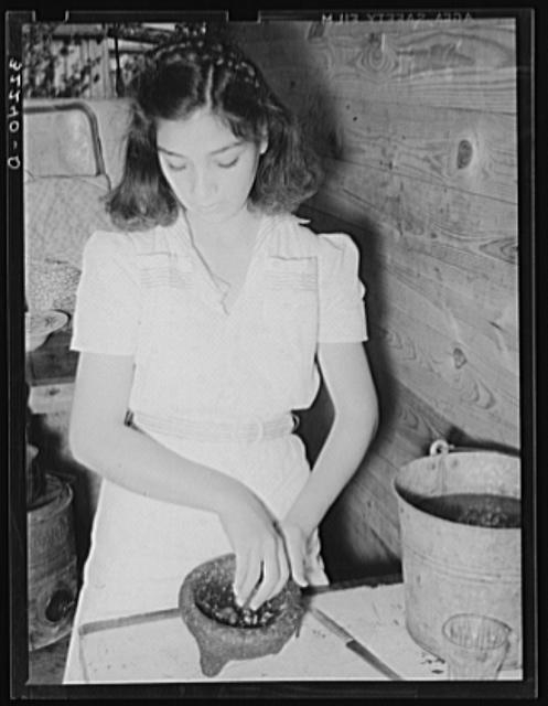 Mexican girl grinding peppers. Robstown, Texas