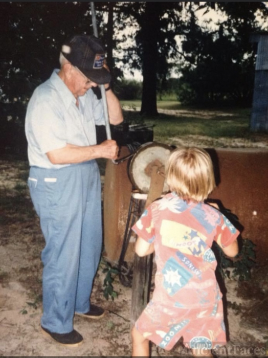 John Collins sharpening his 50 year old hoe. Great grandson Adam Collins provided the muscle to turn the grinding wheel.