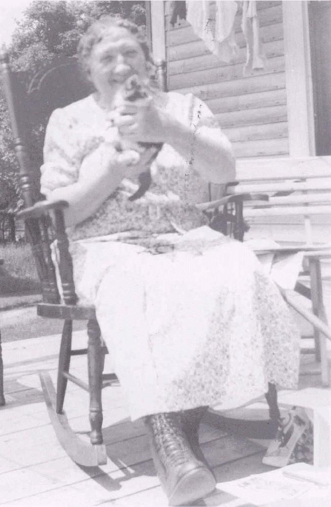 Emma Halkett on her back porch holding a kitten