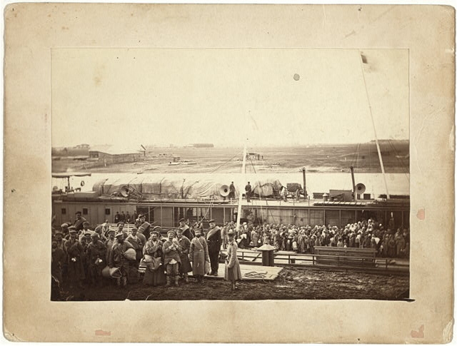 Party of exiles and convicts embarking on river barge at...