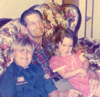 Paul Emrich with two Great grandchildren sitting on his lap.