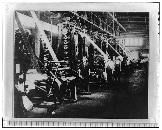 26. A battery of calender presses at work finishing...
