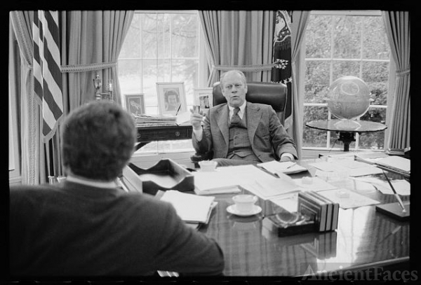 [President Gerald Ford sitting at his desk talking with...