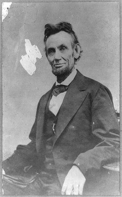 [Abraham Lincoln, half-length, seated, facing front, with...