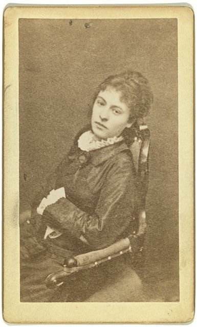 [Three-quarter length portrait of woman, seated in chair,...