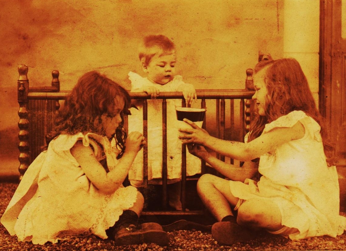 Three girls with crib and cup