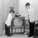 Robert's sons in front of a television he invented.