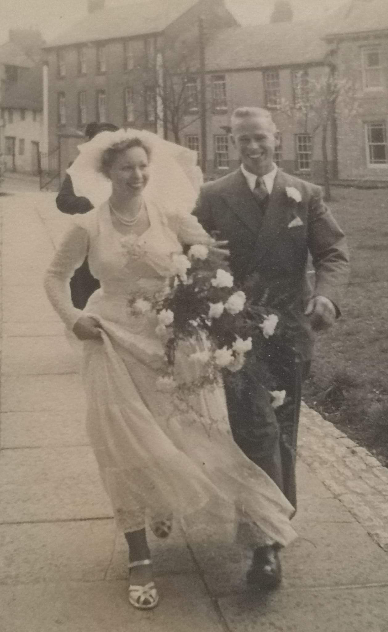 John Collett walking sister Joyce Collett up the path to St Edburg's Church, Bicester, 1952