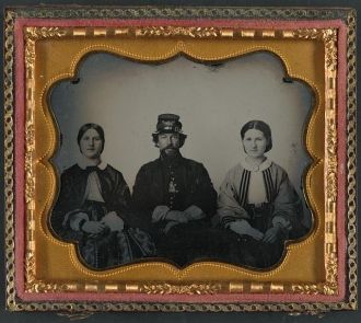 Civil War Infantryman Between Two Women (Possibly Relatives)