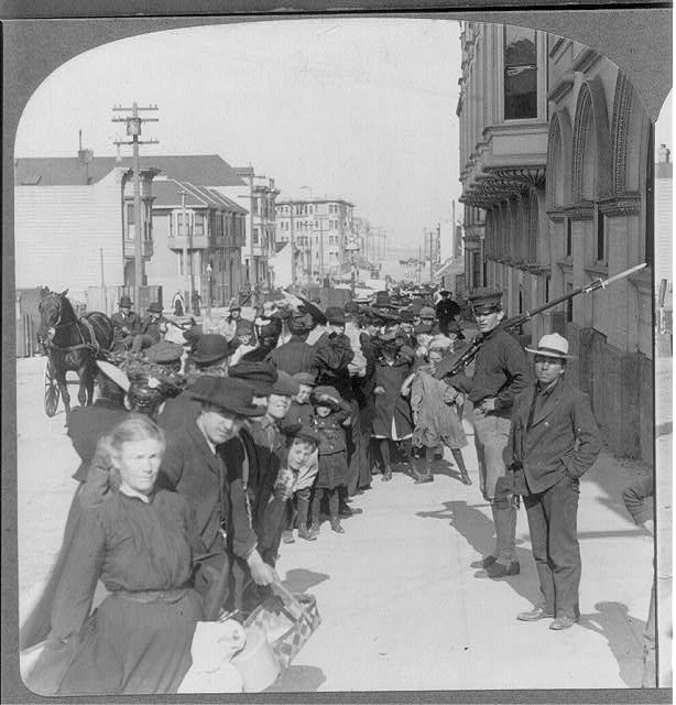 Section of long line of refugees awaiting distribution of...