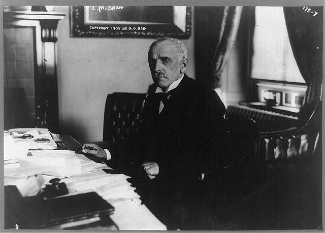 [Leslie M. Shaw, half-length portrait, seated at desk,...
