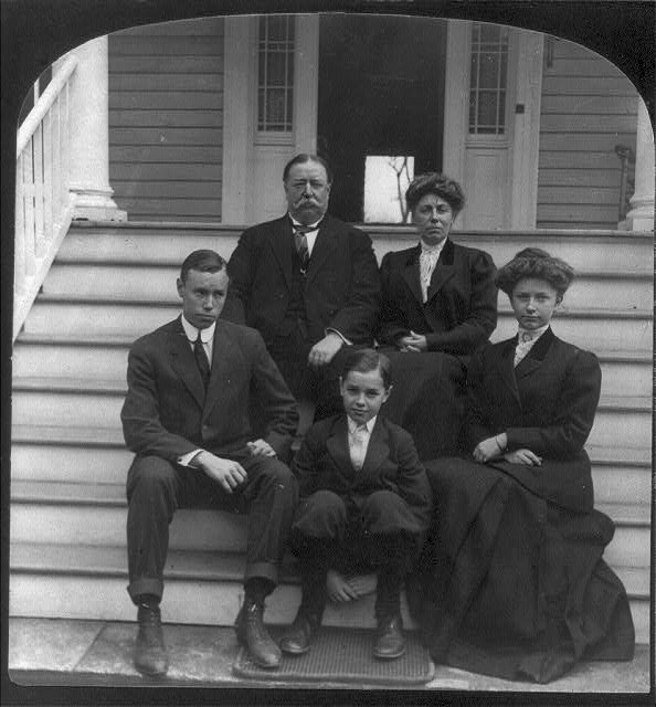 [William Howard Taft, seated, facing front, with family...