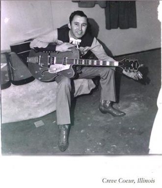 Man seated, with guitar