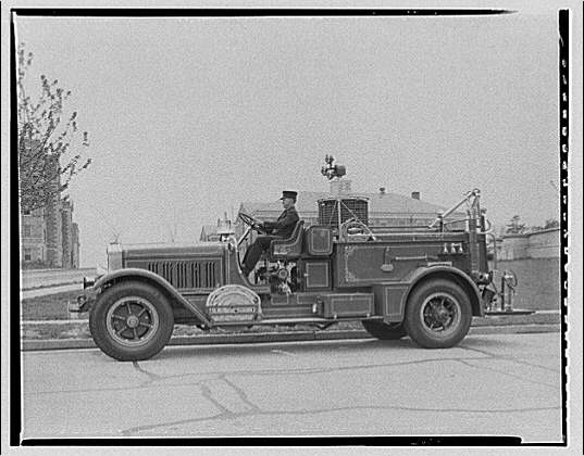 Fire engine. Man at wheel of fire engine