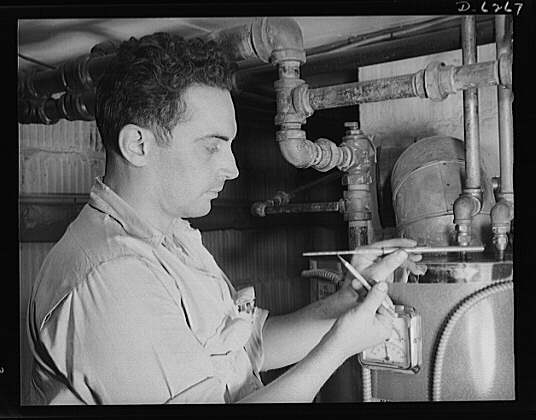 Fuel oil conservation. An experienced serviceman checks...