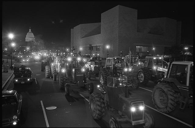 [Farmers driving tractors at night on Pennsylvania...